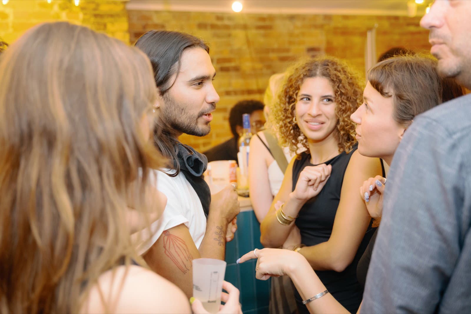 Guests chatting over drinks at the Montreal 2026 hackathon welcome party
