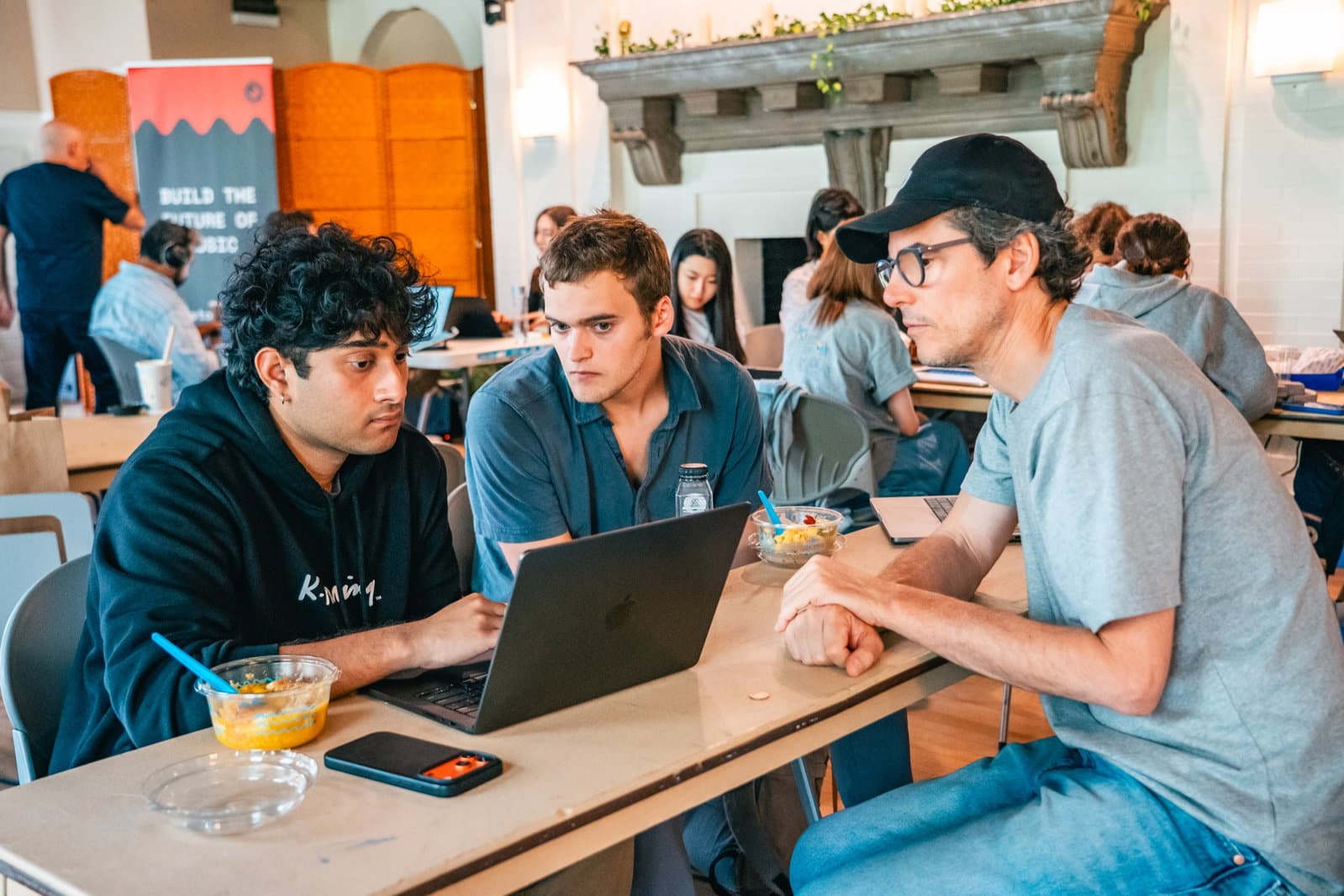 A jury member mentors a hacking team at Boston 2026